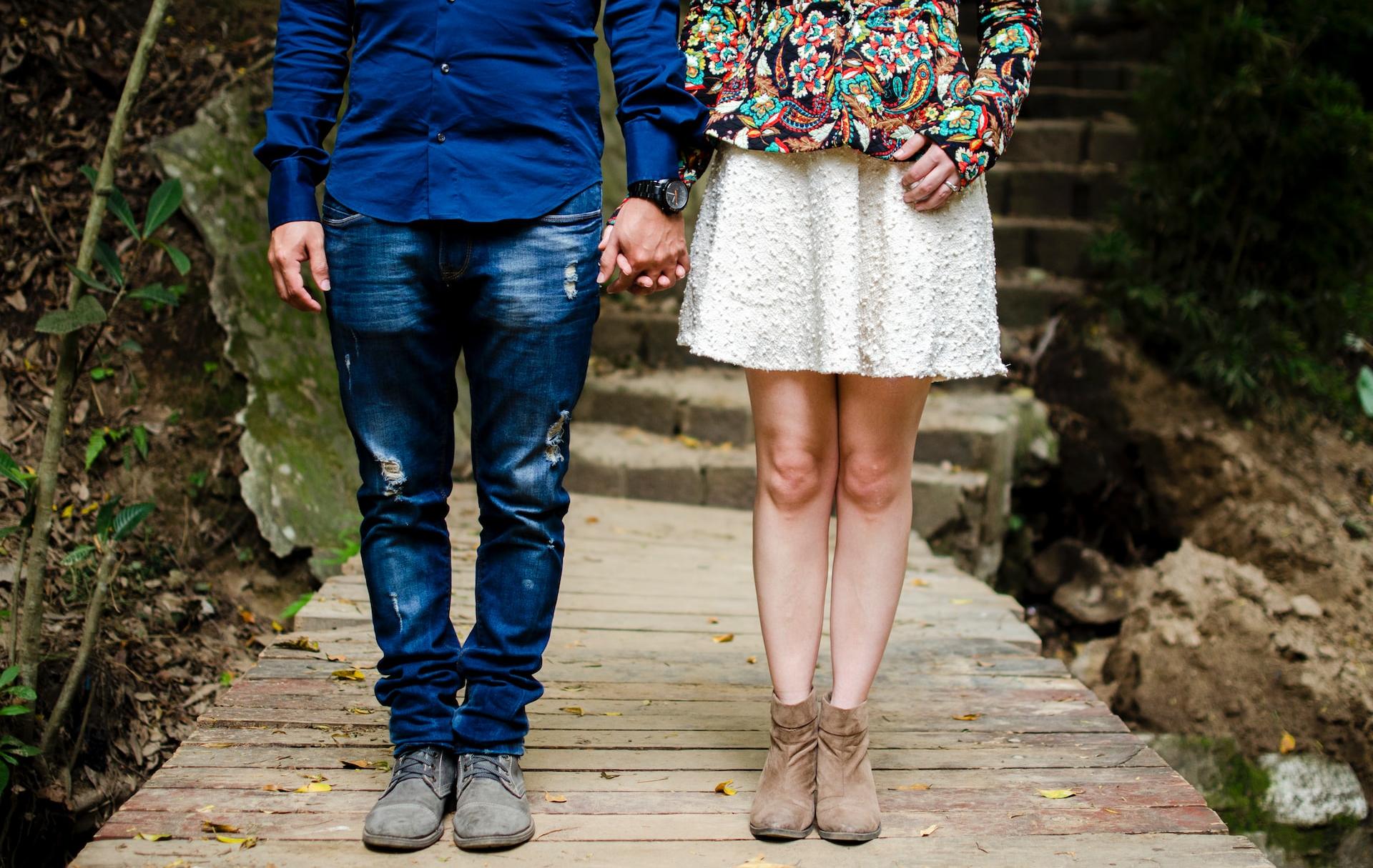 man and woman holding hands during daytime